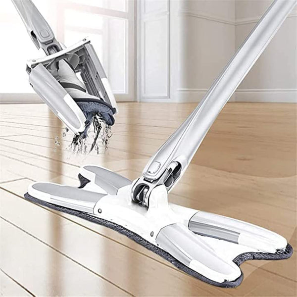 A hands-free squeeze microfiber flat mop system with a 360° flexible head being used on a wooden floor, featuring a white mop with a blue microfiber pad and a silver metal handle.